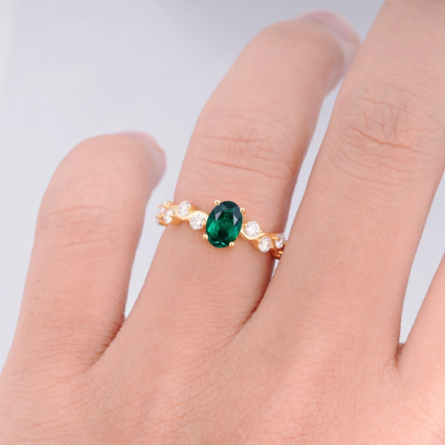Unique Oval Emerald Ring with Pave Set Stones