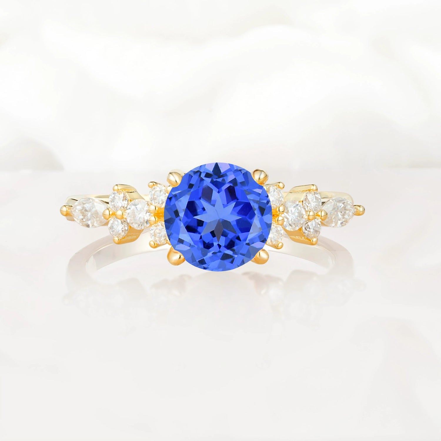 Round Cut Sapphire Engagement Ring with Floral Side Stone Design