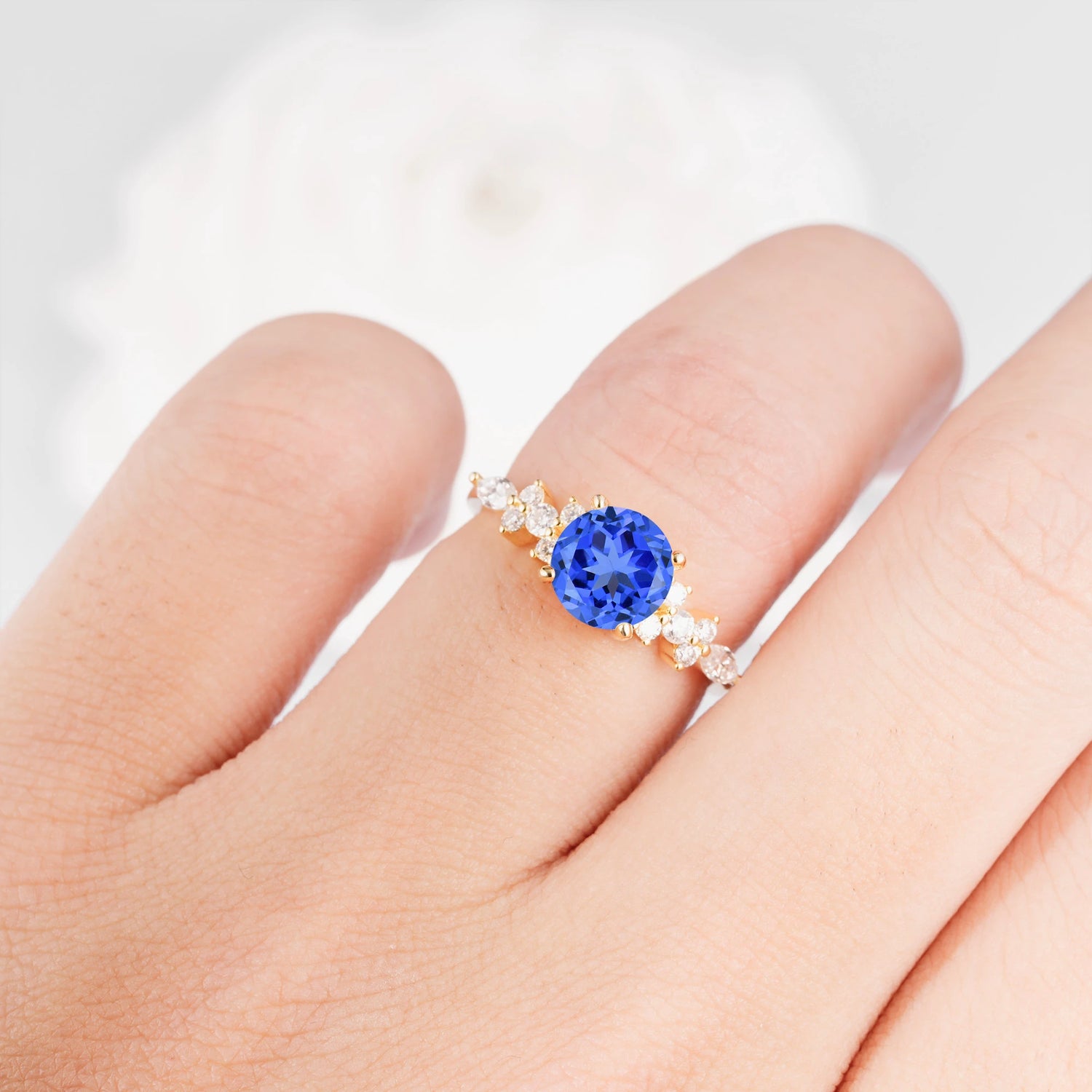 Round Cut Sapphire Engagement Ring with Floral Side Stone Design