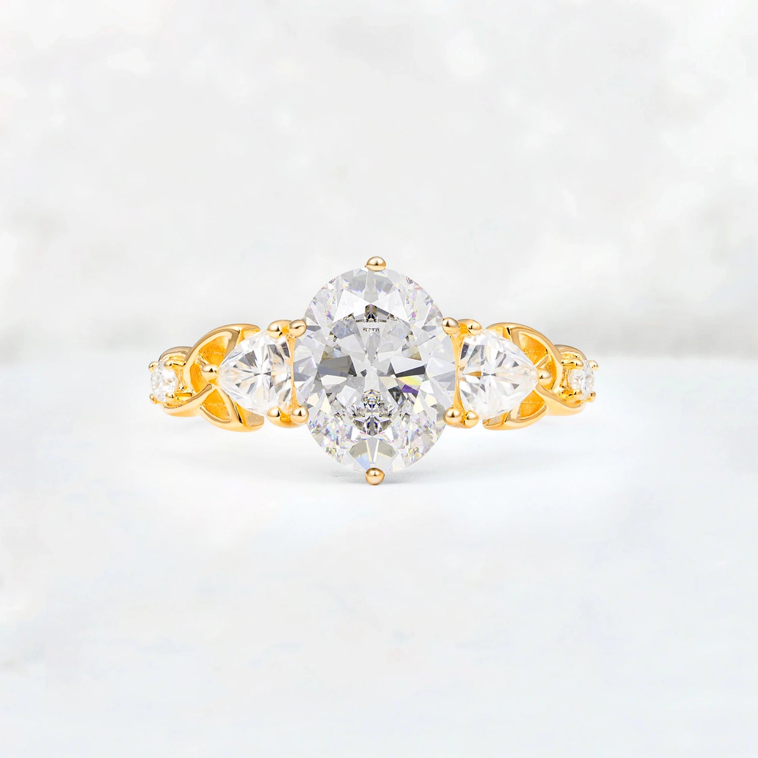 Romantic Three-Stone Oval Moissanite Engagement Ring with Pear Round Accents