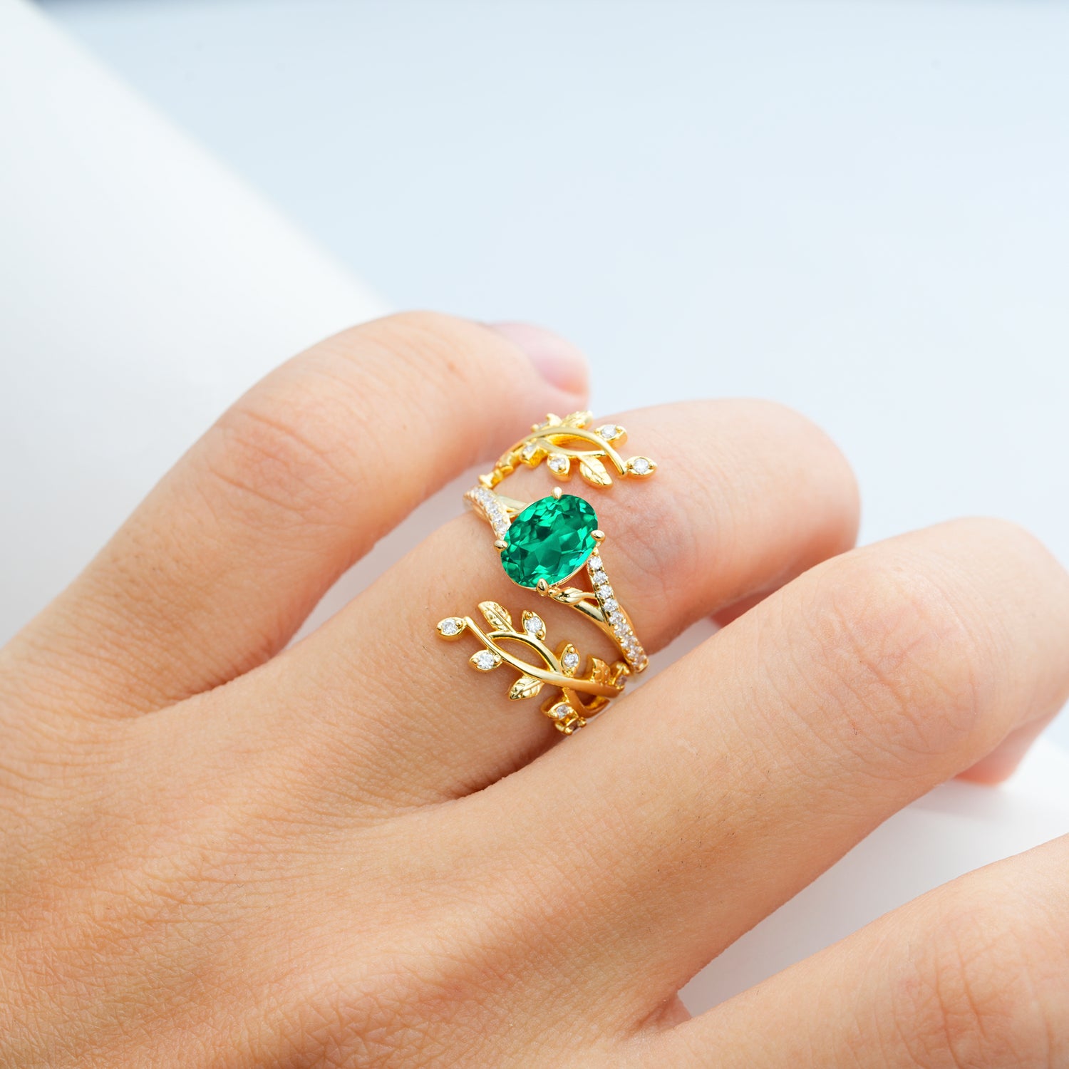 Nature-Inspired Gold Leaf Emerald Bridal Ring Set with Oval Cut