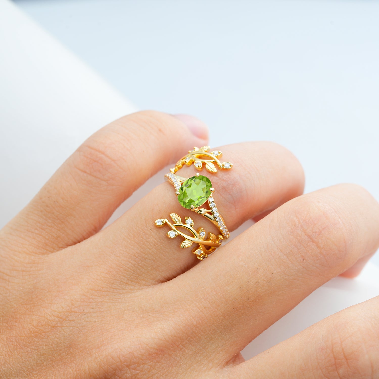 Nature-Inspired Gold Leaf Peridot Bridal Ring Set with Oval Cut