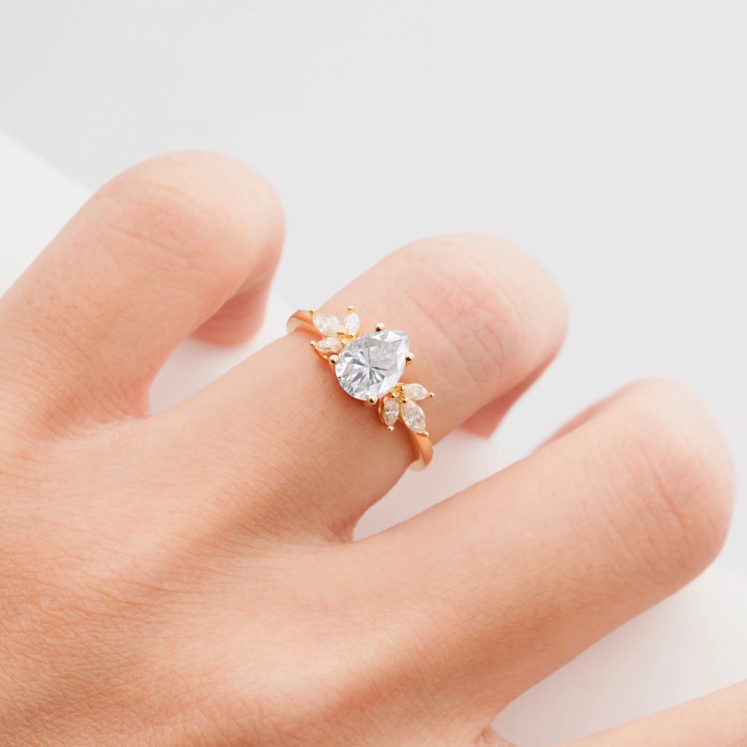 Elegant Pear-Shaped Moissanite Engagement Ring with Floral Side Stones