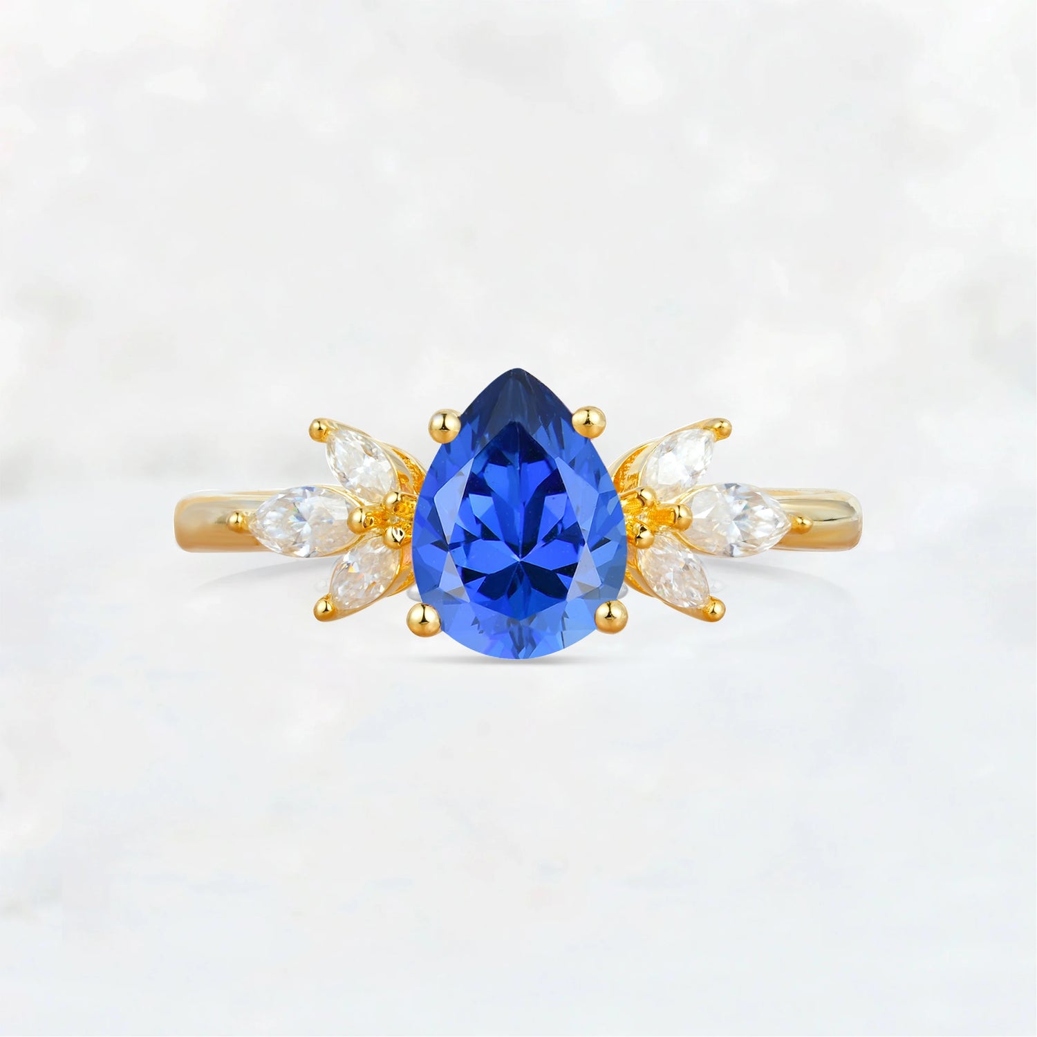 Elegant Pear-Shaped Sapphire Engagement Ring with Floral Side Stones