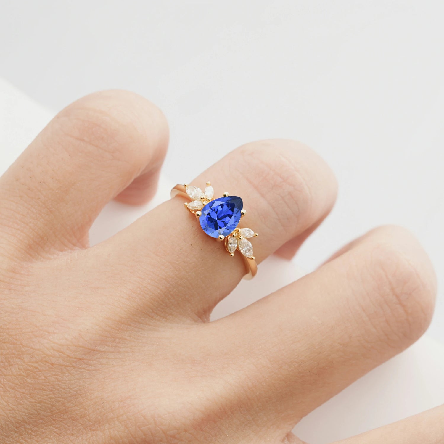 Elegant Pear-Shaped Sapphire Engagement Ring with Floral Side Stones