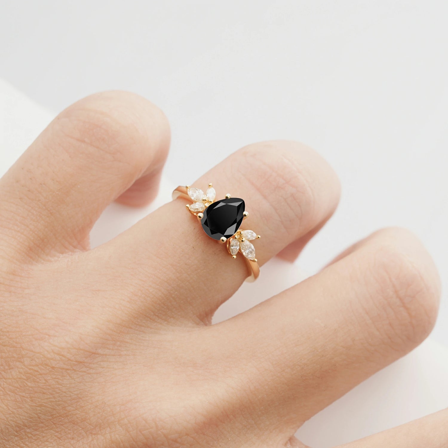 Elegant Pear-Shaped Black Onyx Engagement Ring with Floral Side Stones