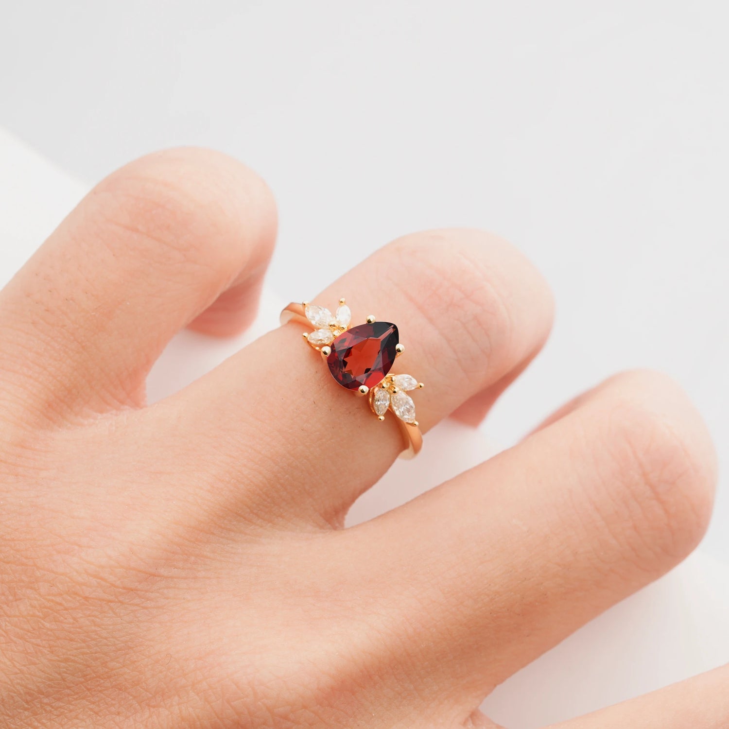 Elegant Pear-Shaped Garnet Engagement Ring with Floral Side Stones