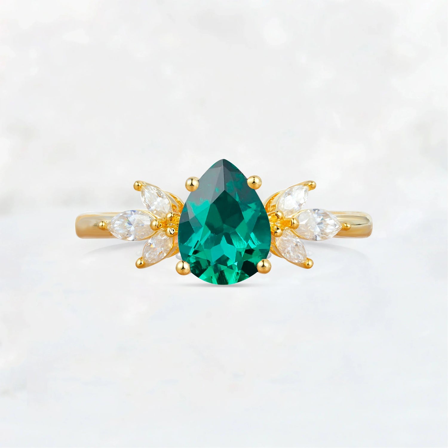Elegant Pear-Shaped Emerald Engagement Ring with Floral Side Stones