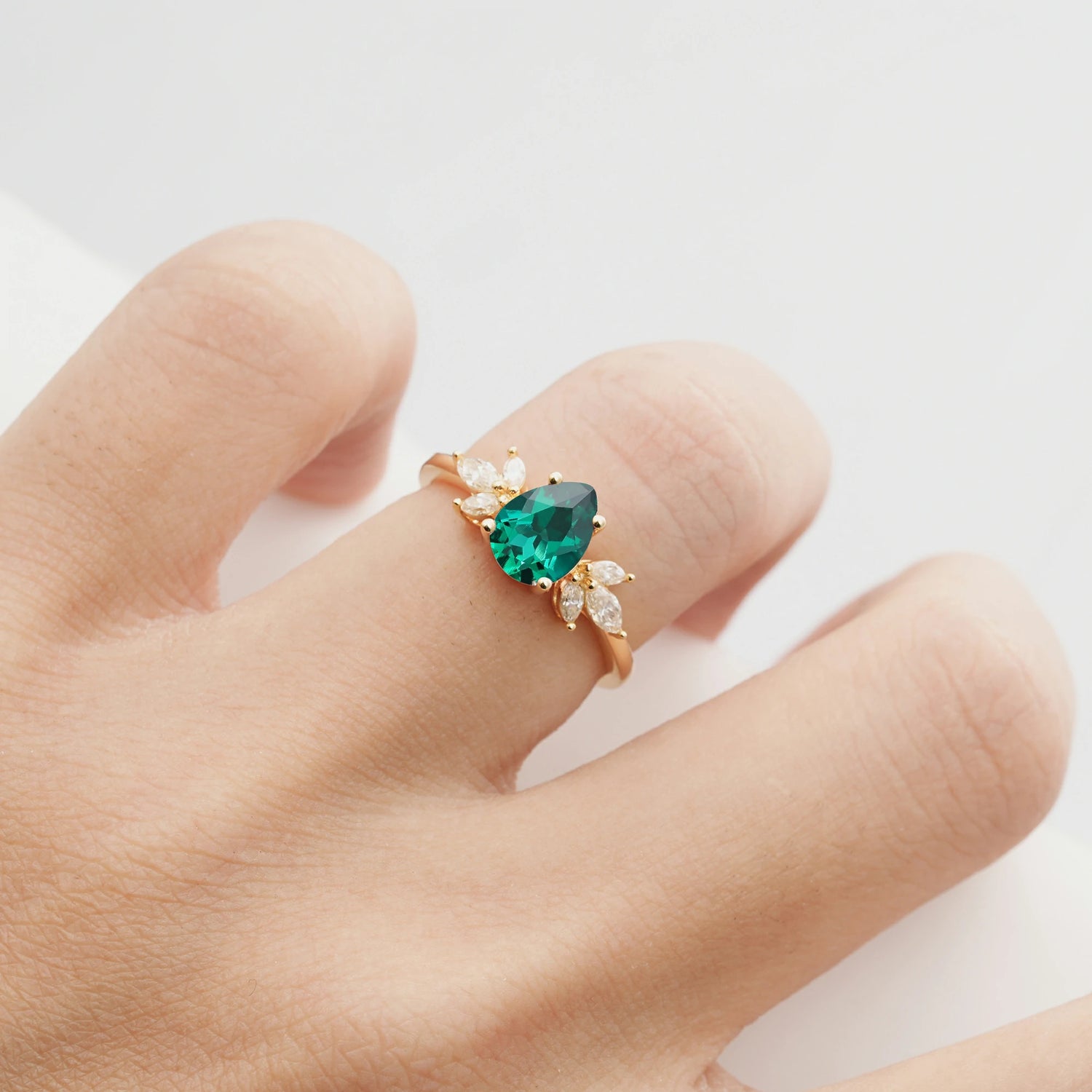Elegant Pear-Shaped Emerald Engagement Ring with Floral Side Stones