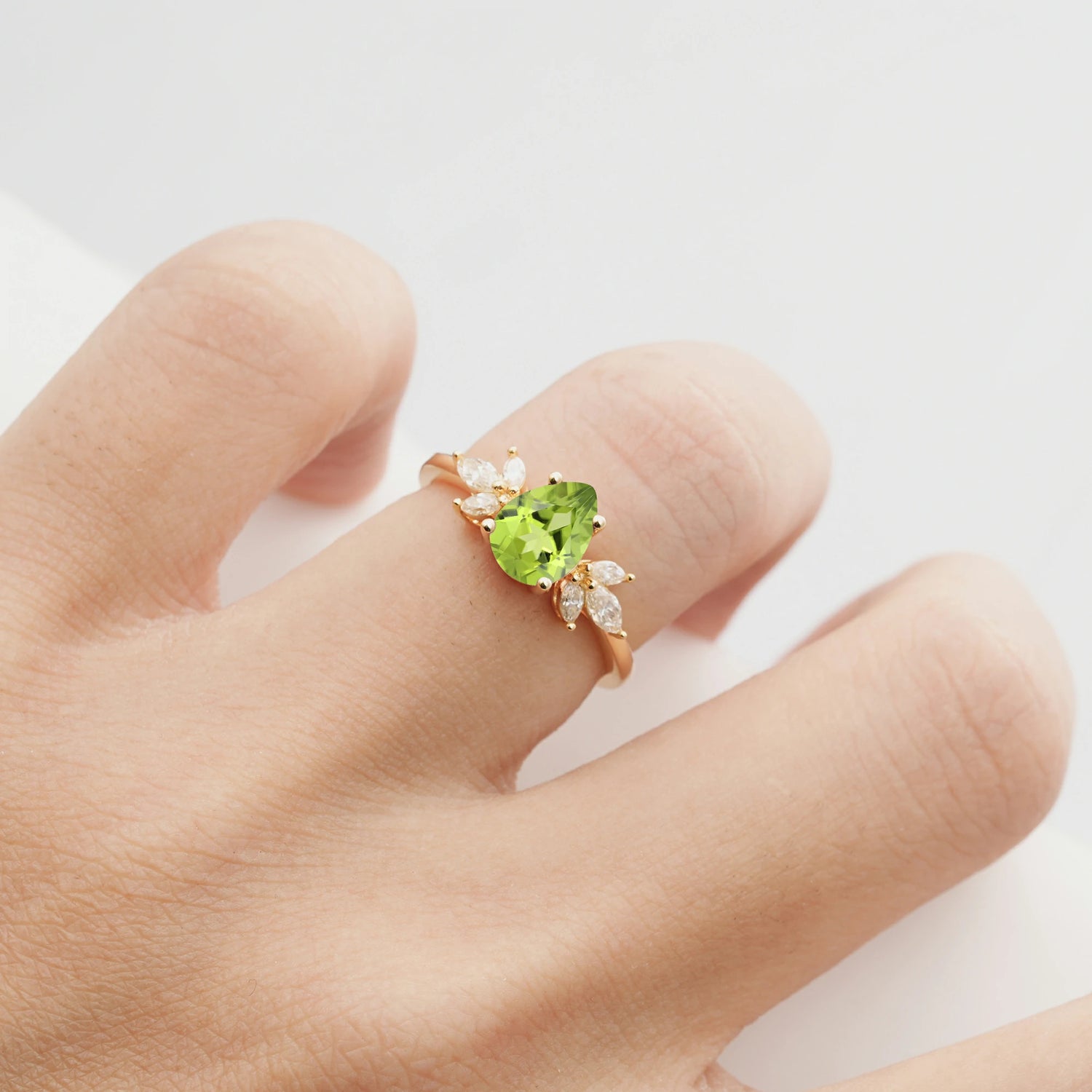 Elegant Pear-Shaped Peridot Engagement Ring with Floral Side Stones