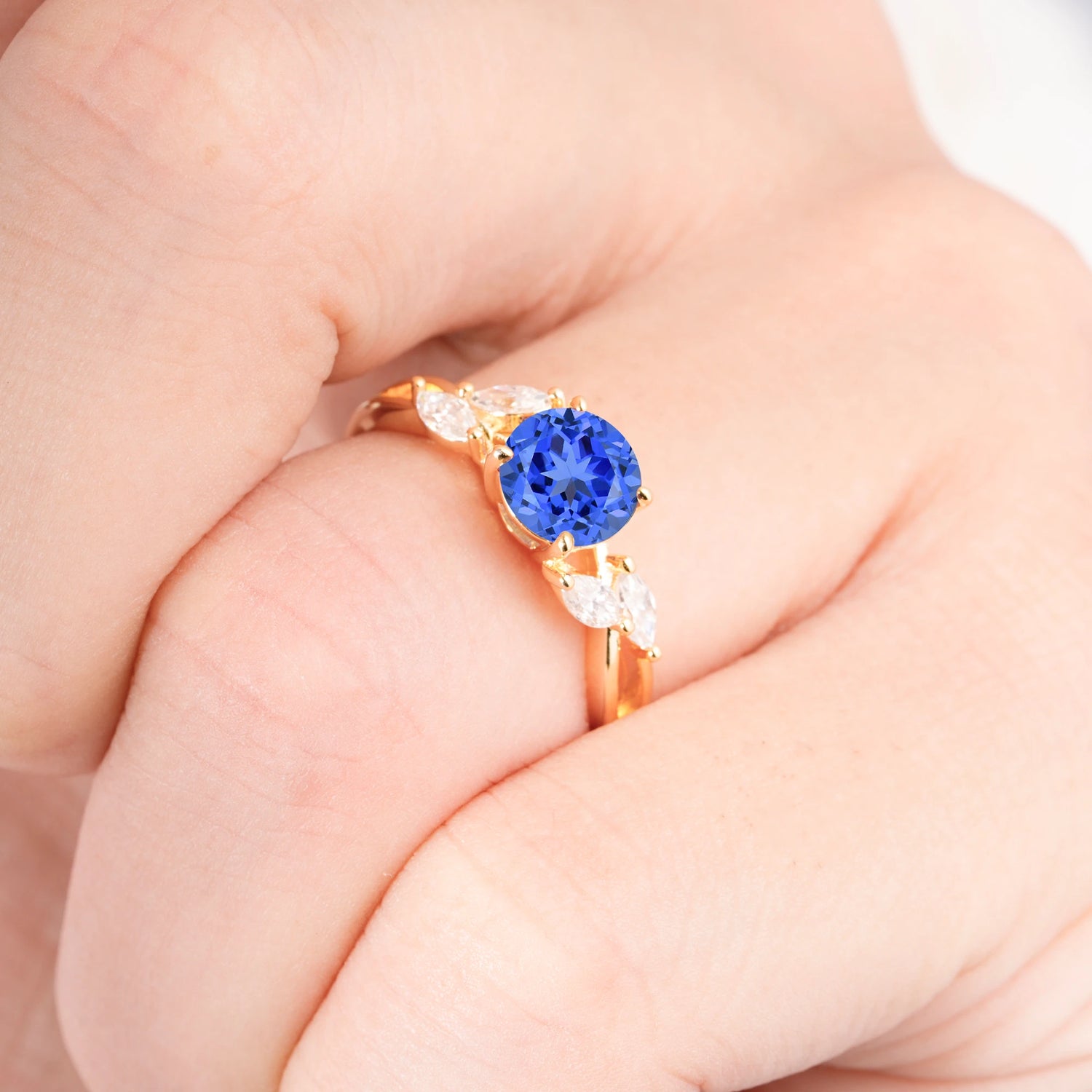 Twisted Band Round Cut Sapphire Engagement Ring with Marquise Accent