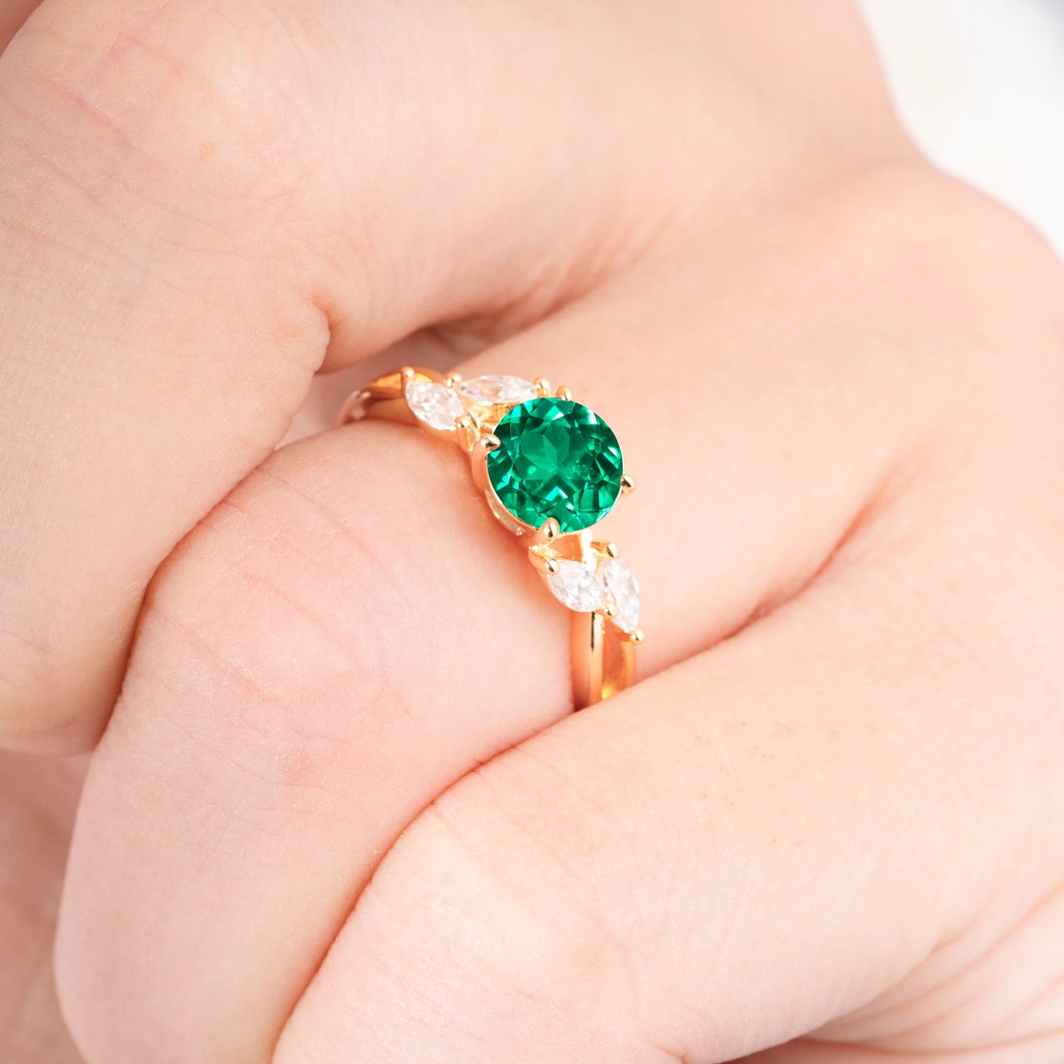 Twisted Band Round Cut Emerald Engagement Ring with Marquise Accent